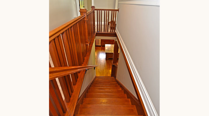 ICH Builders Mt. Sterling residence custom build looking down the wooden stairs towards the main floor below